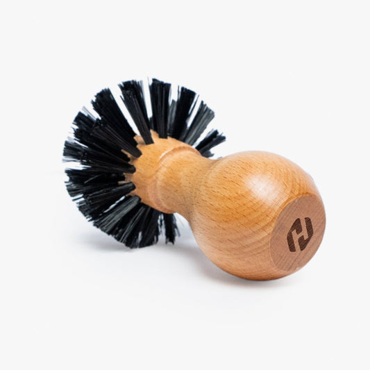 Wooden brush with black bristles on a white background