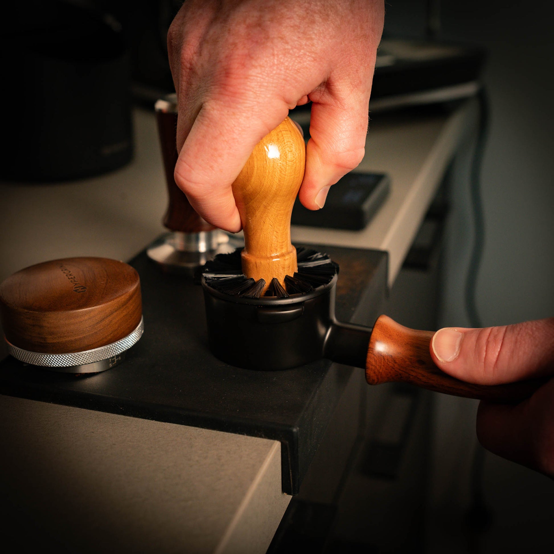 Portafilter Cleaning Brush being used inside a black portafilter head